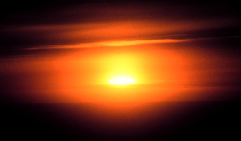 haze_and_clouds_obscure_the_setting_sun_-_noaa