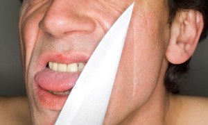 Man holding knife, close-up, portrait